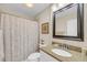 Bathroom with granite countertop, seashell-themed shower curtain, and framed art at 15 Back Ct, Isle of Palms, SC 29451