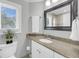 Beautifully decorated bathroom featuring granite counters and a view from the window at 15 Back Ct, Isle of Palms, SC 29451