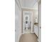 Well-lit hallway to a clean and cozy bathroom with white cabinets and granite countertops at 15 Back Ct, Isle of Palms, SC 29451