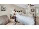 Bedroom with dark wood furniture, ceiling fan, chair and view to stairs and hallway at 15 Back Ct, Isle of Palms, SC 29451