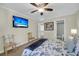 Bedroom with TV, ceiling fan, and adjacent bathroom entrance at 15 Back Ct, Isle of Palms, SC 29451