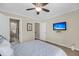 This carpeted bedroom features a ceiling fan and a flatscreen TV for entertainment at 15 Back Ct, Isle of Palms, SC 29451