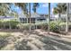 The rear of the house features a large, screened porch and a landscaped yard with mature trees at 15 Back Ct, Isle of Palms, SC 29451