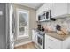 Corner view of the kitchen with modern appliances, granite countertops, and white cabinetry at 15 Back Ct, Isle of Palms, SC 29451