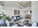 Relaxing screened-in porch with cushioned seating, decorative pillows, tropical plants, and ceiling fan at 15 Back Ct, Isle of Palms, SC 29451