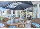 Charming outdoor patio with wicker furniture under a shady umbrella at 15 Back Ct, Isle of Palms, SC 29451