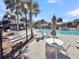 Lounge by the sparkling pool with comfortable seating and lush landscaping in this resort style setting at 15 Back Ct, Isle of Palms, SC 29451
