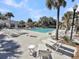 Relax poolside with plenty of seating and lush palm trees creating a perfect vacation atmosphere at 15 Back Ct, Isle of Palms, SC 29451