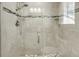 Tiled walk-in shower with glass door, overhead, and handheld fixtures at 15 Back Ct, Isle of Palms, SC 29451