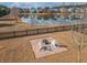 Aerial view of a backyard with brick patio, fire pit, and lake views providing an ideal outdoor retreat at 158 Sandshell Dr, Charleston, SC 29492