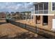 Backyard with a black fence overlooking a tranquil pond in a community setting at 158 Sandshell Dr, Charleston, SC 29492