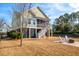 Spacious backyard with a fire pit, chairs, and a view of the home's elevated porch at 158 Sandshell Dr, Charleston, SC 29492