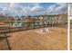 Backyard with grass, a pond, and patio set with chairs at 158 Sandshell Dr, Charleston, SC 29492