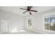Neutral bedroom with a ceiling fan, white carpet, and two windows allowing lots of natural light at 158 Sandshell Dr, Charleston, SC 29492