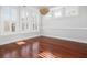 Airy dining room with hardwood floors, white trim, and plantation shutters, creating a bright and welcoming space for Gathering gatherings at 158 Sandshell Dr, Charleston, SC 29492