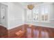Bright and open dining room with hardwood floors, large windows, and a stylish chandelier, creating an inviting ambiance at 158 Sandshell Dr, Charleston, SC 29492