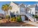 Charming two-story home featuring double garages, inviting porch, and classic American architectural details at 158 Sandshell Dr, Charleston, SC 29492