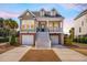 Charming two-story home featuring double garages, inviting porch, and classic American architectural details at 158 Sandshell Dr, Charleston, SC 29492