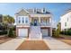 Charming two-story home featuring double garages, inviting porch, and classic American architectural details at 158 Sandshell Dr, Charleston, SC 29492