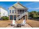 Exterior elevation with a view of a porch, patio, and fenced yard at 158 Sandshell Dr, Charleston, SC 29492