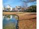 Scenic exterior view of charming homes reflected in the tranquil lake at 158 Sandshell Dr, Charleston, SC 29492