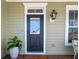 Charming front entrance with a stylish door, exterior lantern, and a welcoming 'WELCOME' mat, creating a warm and inviting arrival at 158 Sandshell Dr, Charleston, SC 29492