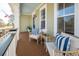 Inviting front porch featuring stylish seating, creating a cozy and welcoming outdoor space with a view of the neighborhood at 158 Sandshell Dr, Charleston, SC 29492