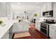 Modern kitchen featuring white cabinetry, quartz countertops, stainless steel appliances, and wood flooring at 158 Sandshell Dr, Charleston, SC 29492