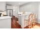 Bright kitchen with stainless steel appliances, white cabinets, hardwood floors, and a breakfast bar at 158 Sandshell Dr, Charleston, SC 29492