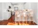 Well-lit kitchen with stainless steel appliances, white cabinets, a breakfast bar, and hardwood floors at 158 Sandshell Dr, Charleston, SC 29492