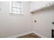 Clean laundry area with white cabinets, tile floor, and window at 158 Sandshell Dr, Charleston, SC 29492