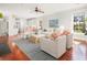 Open living area with hardwood floors, view to kitchen, comfortable seating, and lots of natural light at 158 Sandshell Dr, Charleston, SC 29492