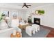 Living room featuring hardwood floors, fireplace, ceiling fan and ample natural light from large windows at 158 Sandshell Dr, Charleston, SC 29492