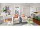 Bright living area with hardwood floors, comfortable chairs, and views to the outside at 158 Sandshell Dr, Charleston, SC 29492