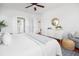 Bright main bedroom boasts a large bed, ceiling fan, and views into the Primary bath at 158 Sandshell Dr, Charleston, SC 29492