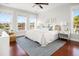 Serene main bedroom with abundant natural light, hardwood floors, and elegant, comfortable furnishings at 158 Sandshell Dr, Charleston, SC 29492