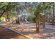 A nice, shaded playground featuring slides, swings, and climbing structures at 158 Sandshell Dr, Charleston, SC 29492
