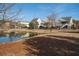 Community pond reflecting surrounding homes and trees on a clear day at 158 Sandshell Dr, Charleston, SC 29492