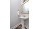 Elegant powder room features a pedestal sink and decorative mirror in a neutral color palette at 158 Sandshell Dr, Charleston, SC 29492