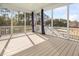 Screened in porch with painted wood flooring overlooking fenced yard and wooded area at 158 Sandshell Dr, Charleston, SC 29492