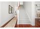 Elegant staircase with carpeted steps, wood handrail, and white trim, seamlessly connecting the home's living spaces and adding style at 158 Sandshell Dr, Charleston, SC 29492