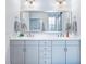 Bathroom featuring a double vanity, a large mirror, and a view of a walk-in tiled shower at 170 Callibluff Dr, Summerville, SC 29486
