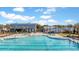 Large community pool area featuring a pool house, outdoor seating, and ample lounge chairs at 170 Callibluff Dr, Summerville, SC 29486