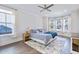 Spacious main bedroom with a ceiling fan, hardwood floors, and natural light from multiple windows at 170 Callibluff Dr, Summerville, SC 29486