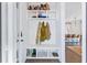 Mudroom has a white bench with hooks, shelves, and a view into the open-concept kitchen at 170 Callibluff Dr, Summerville, SC 29486