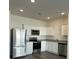 Modern kitchen showcasing stainless steel appliances, white cabinetry, and elegant granite countertops at 1703 Scarlett Maple St, Summerville, SC 29486