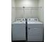 Convenient laundry area equipped with a modern washer and dryer, plus shelving for storage at 1703 Scarlett Maple St, Summerville, SC 29486