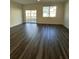 Bright living room featuring sleek flooring and large windows offering ample natural light at 1703 Scarlett Maple St, Summerville, SC 29486