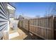 A fenced backyard with a small square of grass and an AC unit outside the siding of the house at 2021 Arbutus Ave, North Charleston, SC 29405