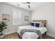This bedroom features a neutral color scheme, shuttered windows, a ceiling fan, and wood-look flooring at 2021 Arbutus Ave, North Charleston, SC 29405